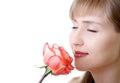 Young beautiful woman rose inhale