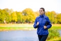 Young Beautiful Woman Running in the Autumn Park Royalty Free Stock Photo