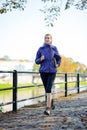 Young Beautiful Woman Running in the Autumn Park Royalty Free Stock Photo