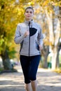 Young Beautiful Woman Running in the Autumn Park Royalty Free Stock Photo