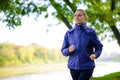 Young Beautiful Woman Running in the Autumn Park Royalty Free Stock Photo