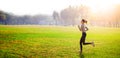 Young beautiful woman running on grass field at morning Royalty Free Stock Photo