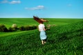 Young beautiful woman running on a green field