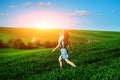 Young beautiful woman running on a green field Royalty Free Stock Photo