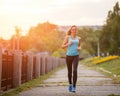 Young beauty woman running in park in the morning Royalty Free Stock Photo