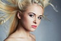 Young beautiful woman. blond girl. Beauty salon.Haircare.Flyi ng hair Royalty Free Stock Photo