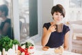 Young beautiful woman with short hair drinking steaming coffee Royalty Free Stock Photo