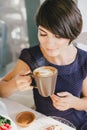 Young beautiful woman with short hair drinking steaming coffee Royalty Free Stock Photo