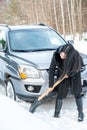 Young beautiful woman shoveling and removing snow from her car, Royalty Free Stock Photo