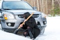 Young beautiful woman shoveling and removing snow from her car, Royalty Free Stock Photo