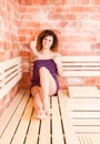 Young beautiful woman showing ok sign when sitting in sauna Royalty Free Stock Photo