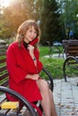 Young beautiful woman sitting on a bench in autumn Park Royalty Free Stock Photo