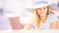 Young beautiful woman sitting in cafe and using smartphone