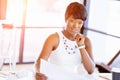 Young woman sitting at a desk in an office and working on blueprint Royalty Free Stock Photo