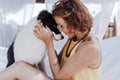 Young beautiful woman sitting on hammock with her border collie dog outdoors. Fun and summer lifestyle Royalty Free Stock Photo