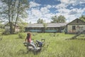 Young beautiful woman sitting inside attraction in the abandoned children summer camp