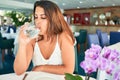 Young beautiful woman sitting at restaurant enjoying summer vacation drinking glass of water Royalty Free Stock Photo