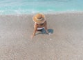 Young beautiful woman is sitting on the sea cost and enjoying waves landscape. Alanya, Turkey