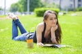 Young beautiful woman sitting in the summer park Royalty Free Stock Photo