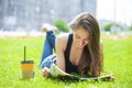 Young beautiful woman sitting in the summer park Royalty Free Stock Photo