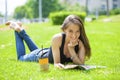 Young beautiful woman sitting in the summer park Royalty Free Stock Photo