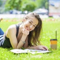 Young beautiful woman sitting in the summer park Royalty Free Stock Photo