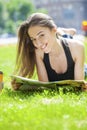 Young beautiful woman sitting in the summer park Royalty Free Stock Photo