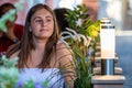 Young woman sitting at table of street cafe and waiting for meeting Royalty Free Stock Photo