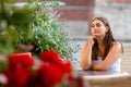 Young woman sitting at table of street cafe and waiting for meeting Royalty Free Stock Photo