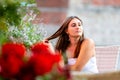 Young woman sitting at table of street cafe and waiting for meeting Royalty Free Stock Photo
