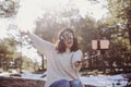 Young beautiful woman sitting on wood trunks and taking a picture with mobile phone. Wearing ski goggles. Back light. Outdoors and Royalty Free Stock Photo