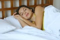 Young beautiful woman sleeping in her bed and relaxing in the morning Royalty Free Stock Photo