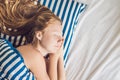 Young beautiful woman sleeping in her bed and relaxing in the morning Royalty Free Stock Photo