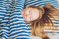 Young beautiful woman sleeping in her bed and relaxing in the morning Royalty Free Stock Photo