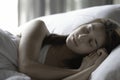 Young beautiful woman sleeping in her bed and relaxing in the morning Royalty Free Stock Photo