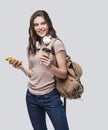 Young beautiful woman with smart phone isolated studio portrait, smiling student girl going on travel Royalty Free Stock Photo