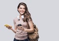 Young beautiful woman with smart phone. Smiling student girl going on a travel. Isolated on gray background Royalty Free Stock Photo