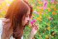 Young beautiful woman smells a flower.