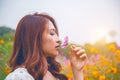 Young beautiful woman smells a flower.