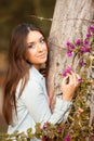 Young beautiful woman smells flowers Royalty Free Stock Photo