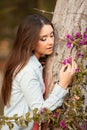 Young beautiful woman smells flowers Royalty Free Stock Photo