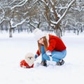 Young beautiful woman with smile walks a dog on a white snowy ba Royalty Free Stock Photo