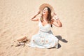 Young beautiful woman smiling happy enjoying summer vacation at the beach sitting on the sun Royalty Free Stock Photo