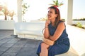 Young beautiful woman smiling happy sitting on a bench of Puerto de la Cruz, Tenerife on a sunny day of summer Royalty Free Stock Photo