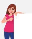 Young beautiful woman smiling and holding a blank / empty sheet of white paper or board and pointing with index finger. Royalty Free Stock Photo