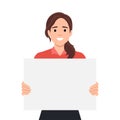 Young beautiful woman smiling and holding a blank empty sheet of white paper or board. Woman showing a empty poster. Human Royalty Free Stock Photo