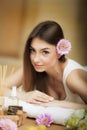 Portrait of a beautiful woman. Skin Care. Spa treatments. Flower in hair. The concept of beauty and health. In the massage salon. Royalty Free Stock Photo