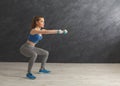 Young beautiful woman in sportswear doing squat Royalty Free Stock Photo