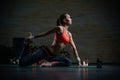 Calm woman stretching her legs and touching foot while practicing yoga Royalty Free Stock Photo