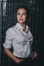 Young beautiful woman standing against black